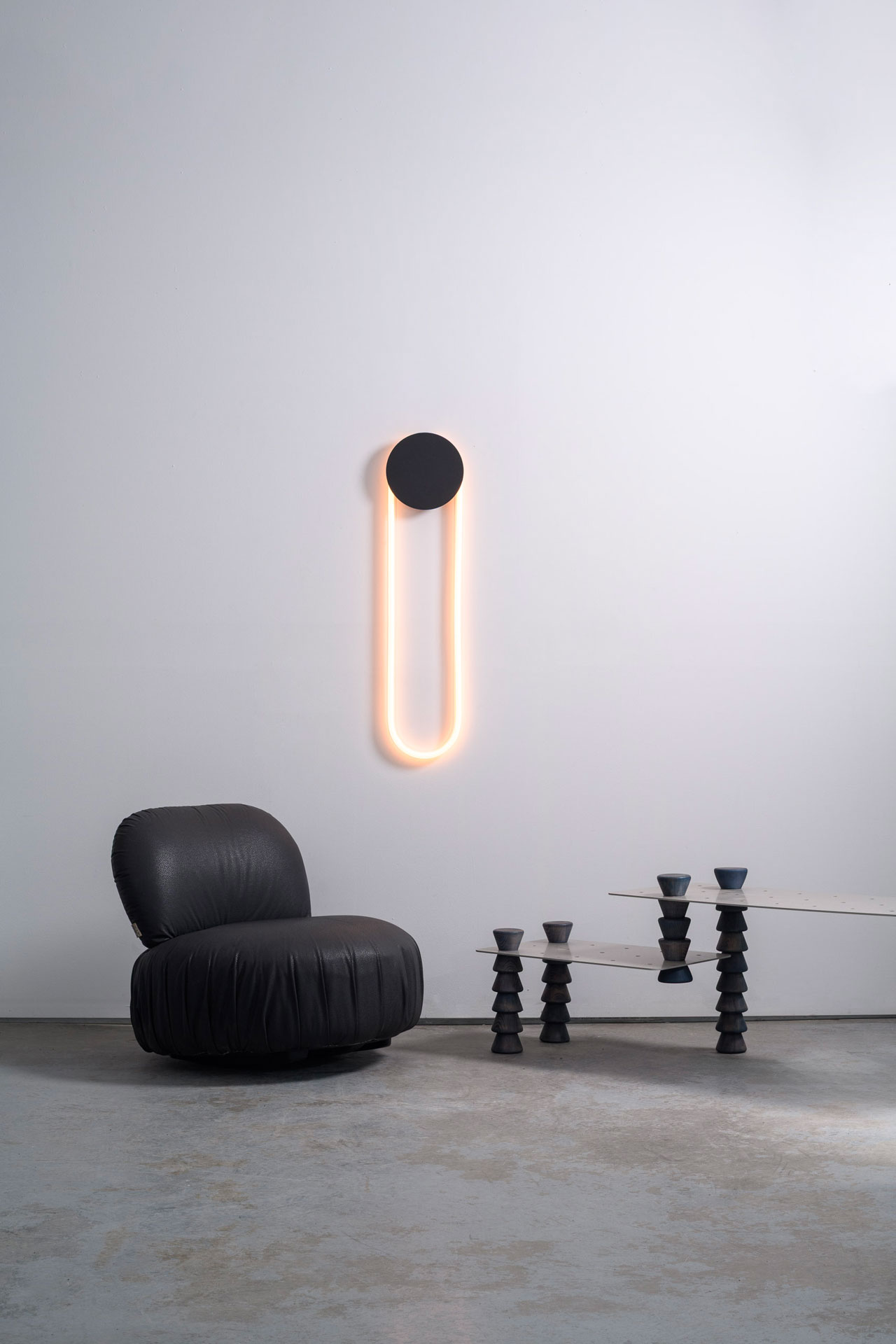 Ra Wall, designed by Alex Joncas, is distinguished by a fascinating duality of strength and delicacy. Like an eclipse, its disk masks a portion of the light while capturing and reflecting the room's nuances.